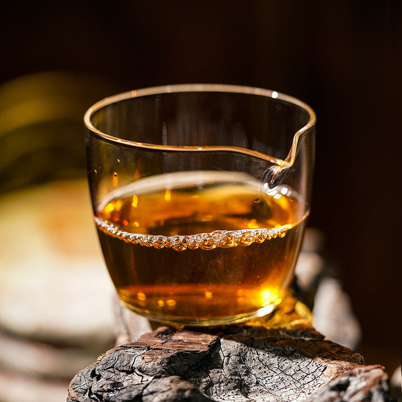 Golden-amber Dingjiazhai sheng pu-erh tea liquor in glass gongdao cup — Yiwu Chinese raw puerh from Yunnan old tree gardens